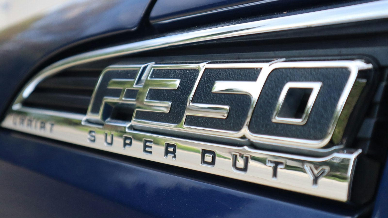Ford F-350 Super Duty fender badge on a blue truck